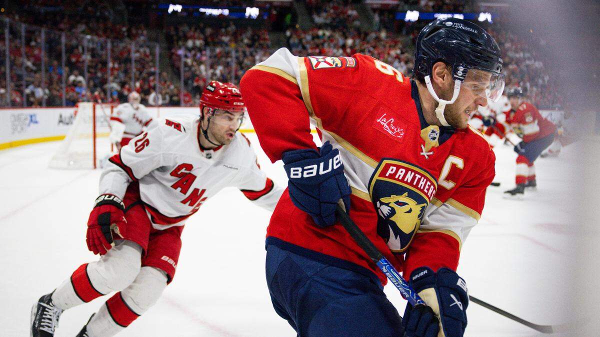 Carolina Hurricanes defenseman Sean Walker (26) chases Florida Panthers center Aleksander Barkov (16), who has the puck, during the second period of a game on Thursday, Jan. 2, 2025, at Amerant Bank Arena in Sunrise, Fla.