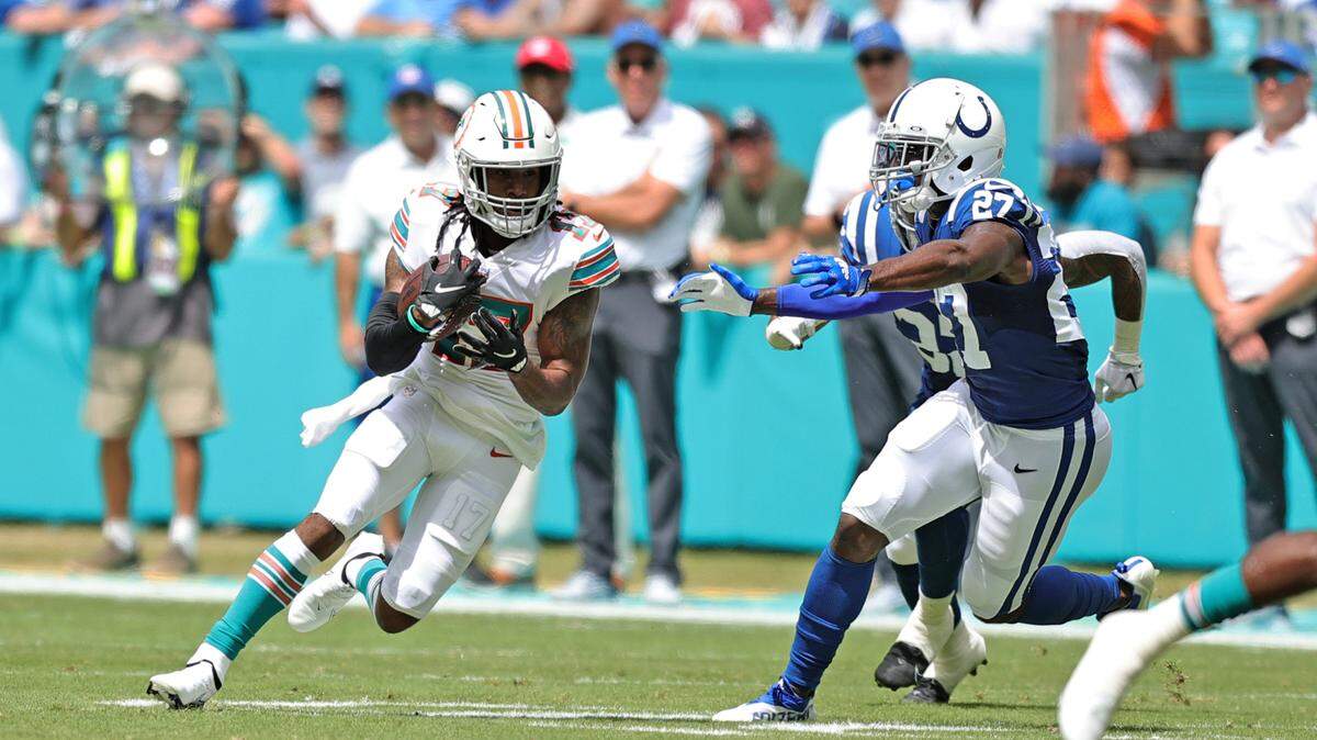 Miami Dolphins wide receiver Jaylen Waddle (17) runs with the ball against Indianapolis Colts cornerback Xavier Rhodes (27) during first quarter of an NFL football game at Hard Rock Stadium on Sunday, October 3, 2021 in Miami Gardens, Florida.