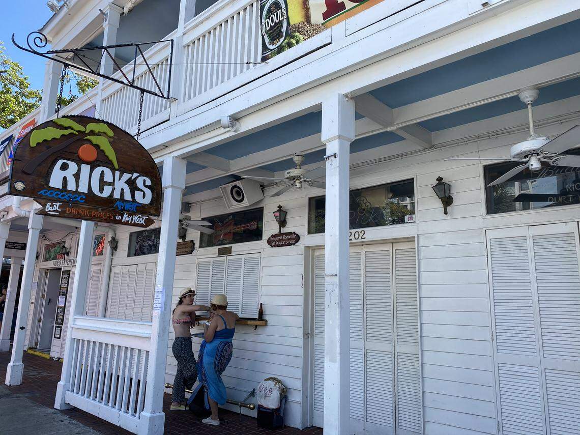 Rick’s Bar on Duval Street was closed March 18, 2020, along with all bars and clubs in Florida, per the governor’s orders. Two women use the outside as a dining table since the city of Key West also shut down on-site dining.