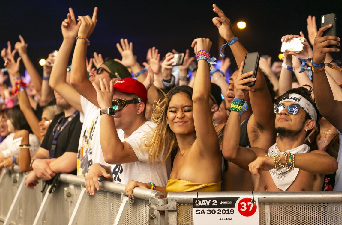 Festival goers enjoy the music and light show Saturday night at Ultra.