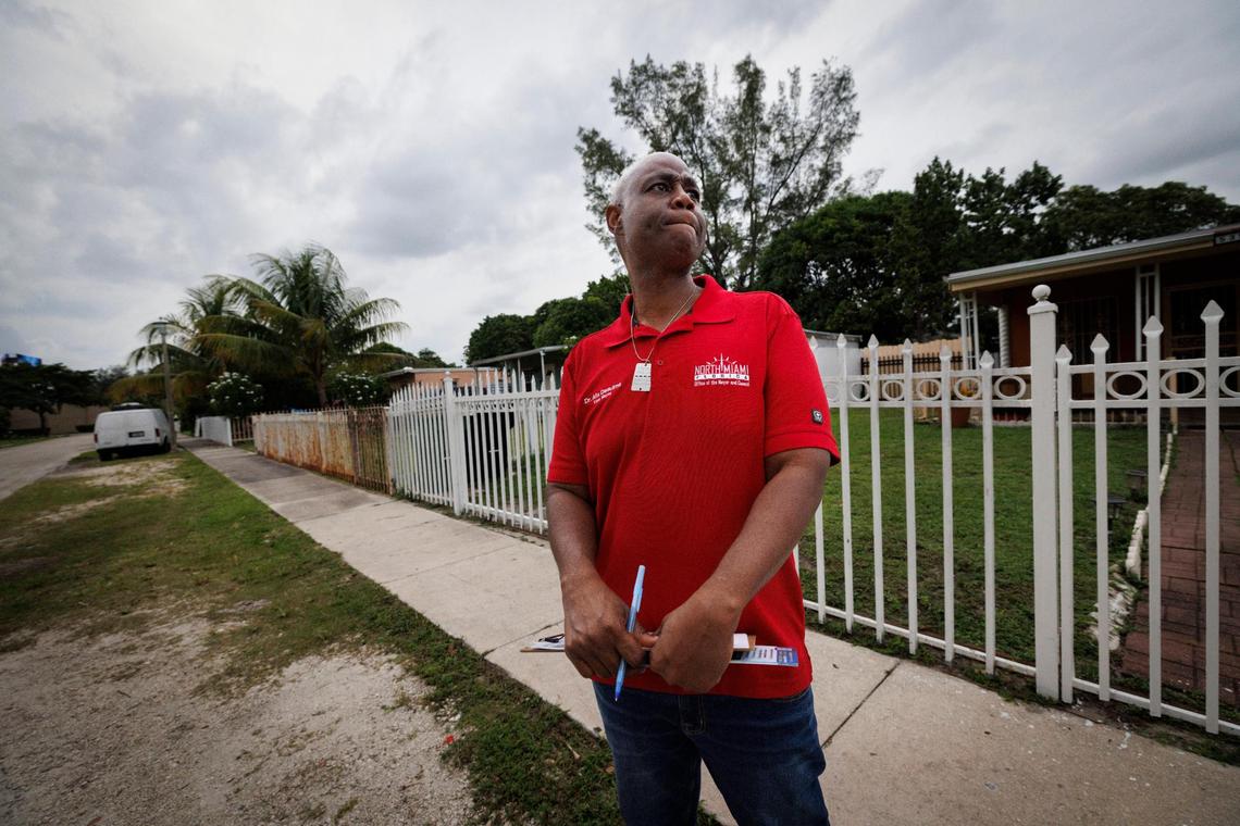 Alix Desulme, appointed North Miami mayor, looks down the street to decide which house to go to next while canvasing for the upcoming mayoral election in North Miami.