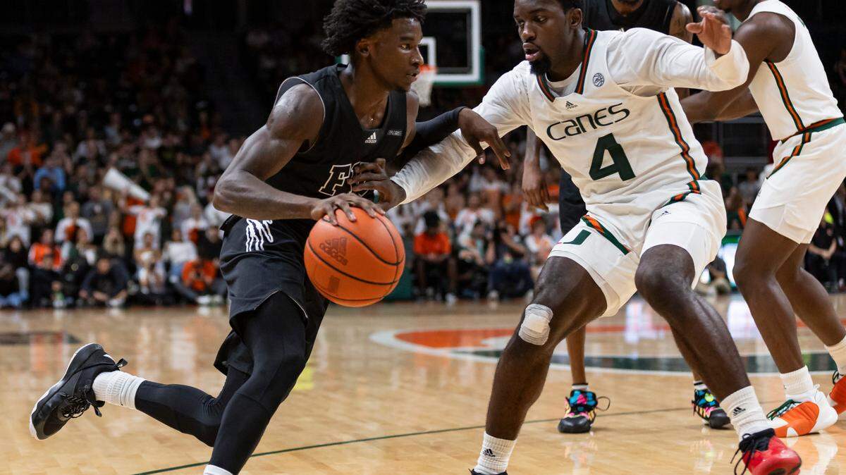 Florida International Golden Panthers guard Arturo Dean (2) drives the ball as Miami Hurricanes guard Bensley Joseph (4) defends in the second half at the Watsco Center on Monday, Nov. 13, 2023. Joseph will be tasked with covering highly-touted Notre Dame freshman guard Markus Barton in their ACC opener Dec. 2, 2023.