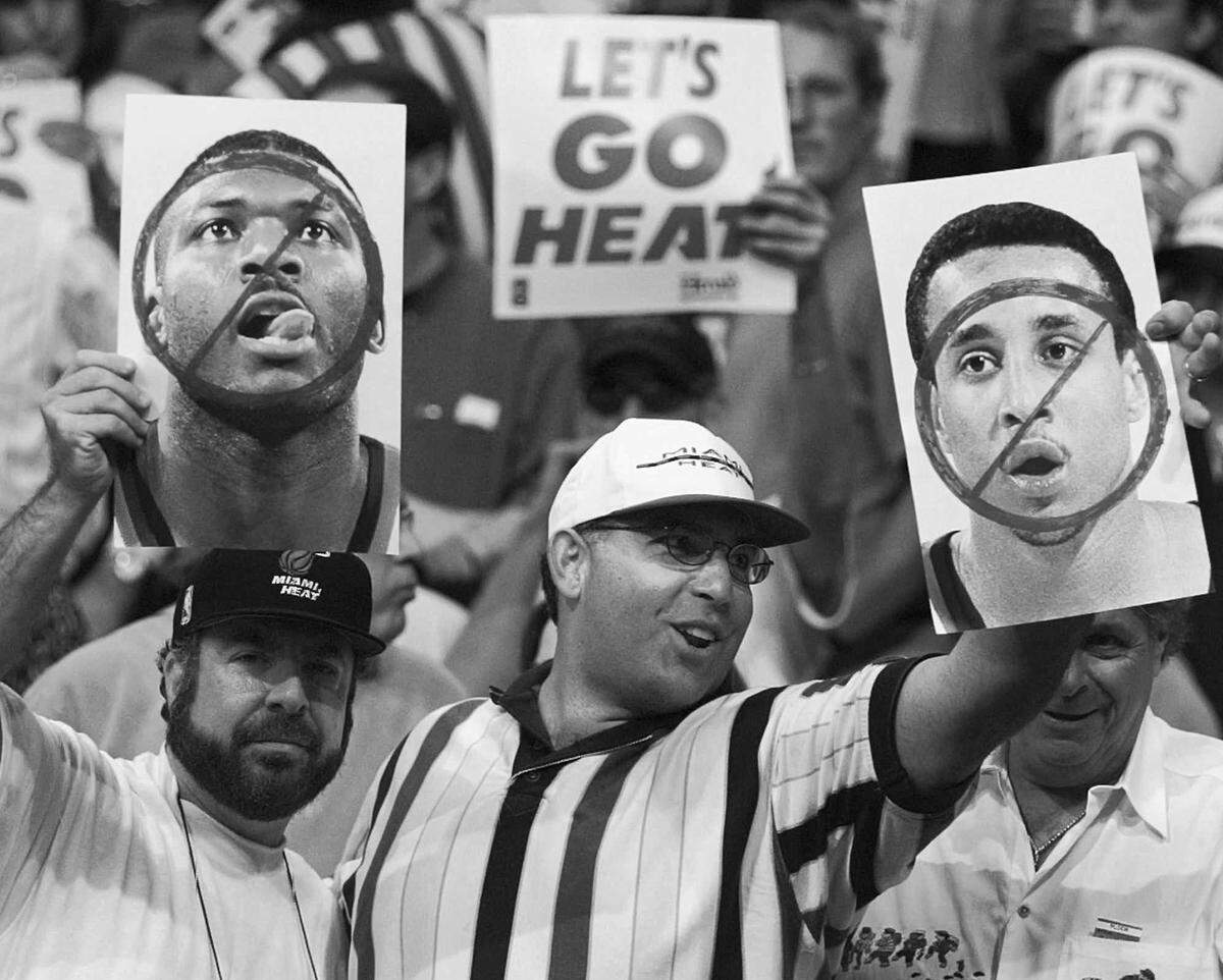 Two exuberant Miami Heat fans show posters of New York Knicks’ Larry Johnson, left, and John Starks, right, Sunday, May 18, 1997 in Miami. Both players were unable to take part in Game 7 of their Eastern Conference semi-final because of suspensions handed down by the NBA resulting from Game 5. (AP Photo/Hans Deryk)