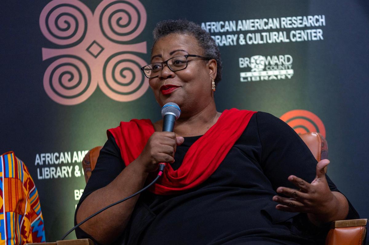 President of the Haitian American Chamber of Commerce, Djenane Gourgue speaks during the Out of Many, One Community: Combating Anti-Immigrant Rhetoric panel discussion hosted by South Florida People of Color at the African-American Cultural Research Center on Thursday, October 17, 2024, in Miami, Fla.