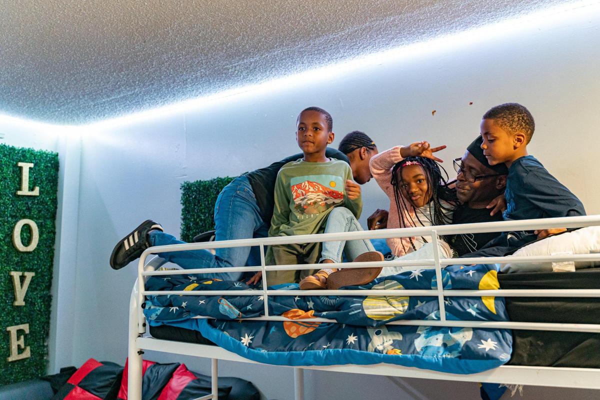 The McKay kids pose for a portrait on the bunk bed in their home.