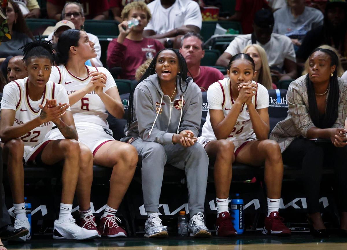 FSU injured star Ta’Niya Latson, center, yells something to the team during the fourth quarter of a game on Sunday, Feb. 16, 2025, at Wastco Center in Coral Gables, Fla. Latson is from Miami and is the nation’s leading scorer.