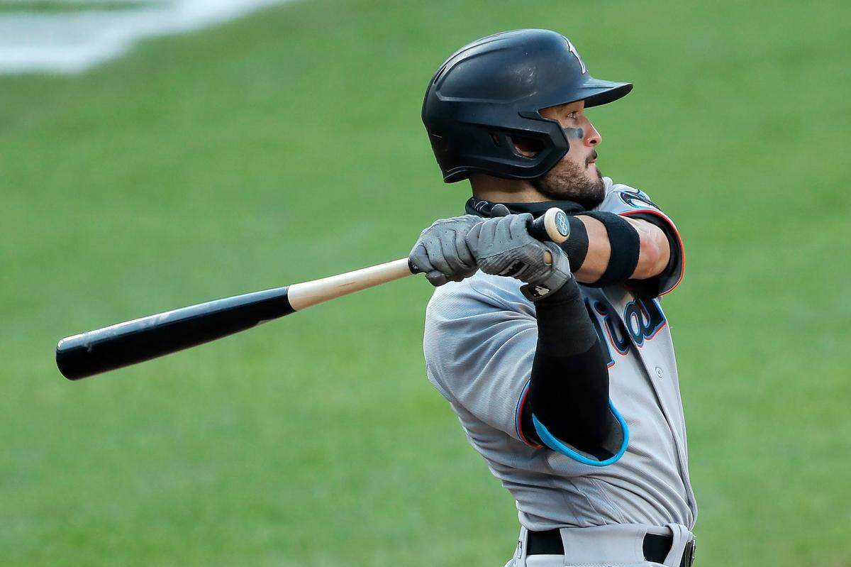 The Olympic rings are seen on the knob of Miami Marlins’ Eddy Alvarez’s bat as he swings at a pitch from the Baltimore Orioles during the seventh inning in the first game of a baseball doubleheader, Wednesday, Aug. 5, 2020, in Baltimore. Among the Marlins’ roster replacements following their coronavirus outbreak was infielder Alvarez, a 2014 Olympic silver medalist in speedskating.