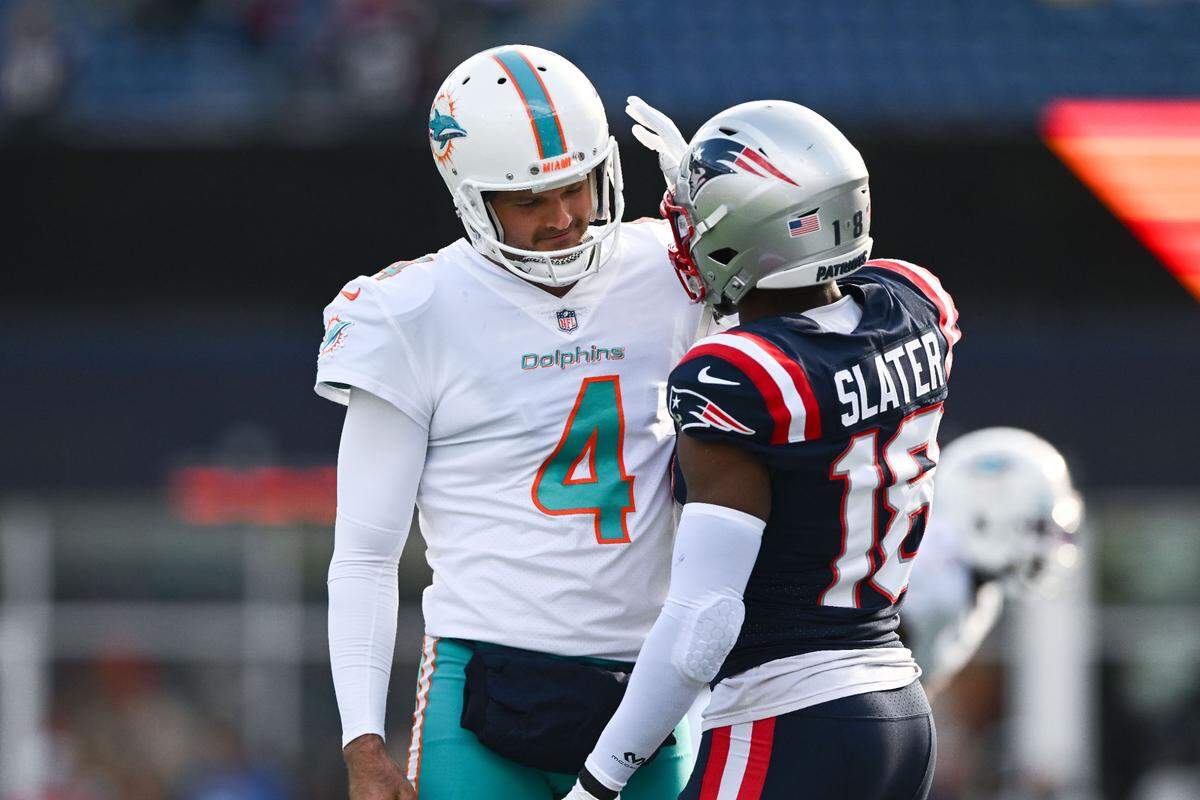 Jan 1, 2023; Foxborough, Massachusetts, USA; New England Patriots wide receiver Matthew Slater (18) talks with Miami Dolphins punter Thomas Morstead (4) before a game at Gillette Stadium. Mandatory Credit: Brian Fluharty-USA TODAY Sports