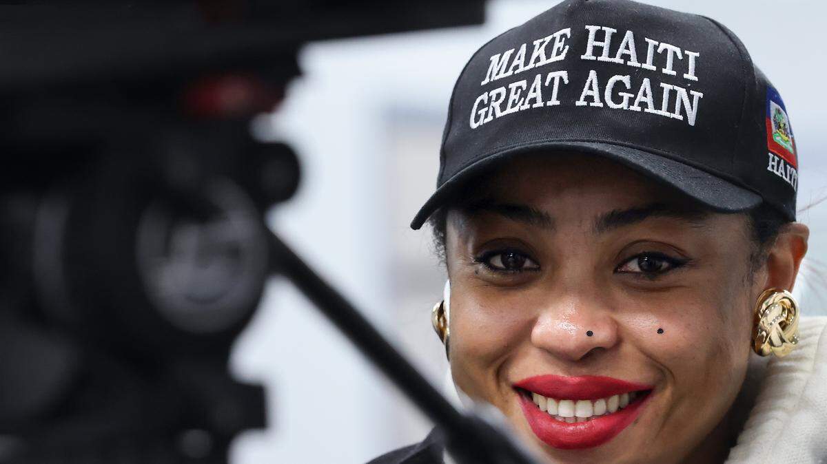 Framed by a local news camera, press conference attendee Sheena Warren Chery, 32, is one of many Haitians who are breathing easier by a judge’s decision to block the Trump administration from ending TPS for Haitians. The press conference was Tuesday at North Miami City Hall.