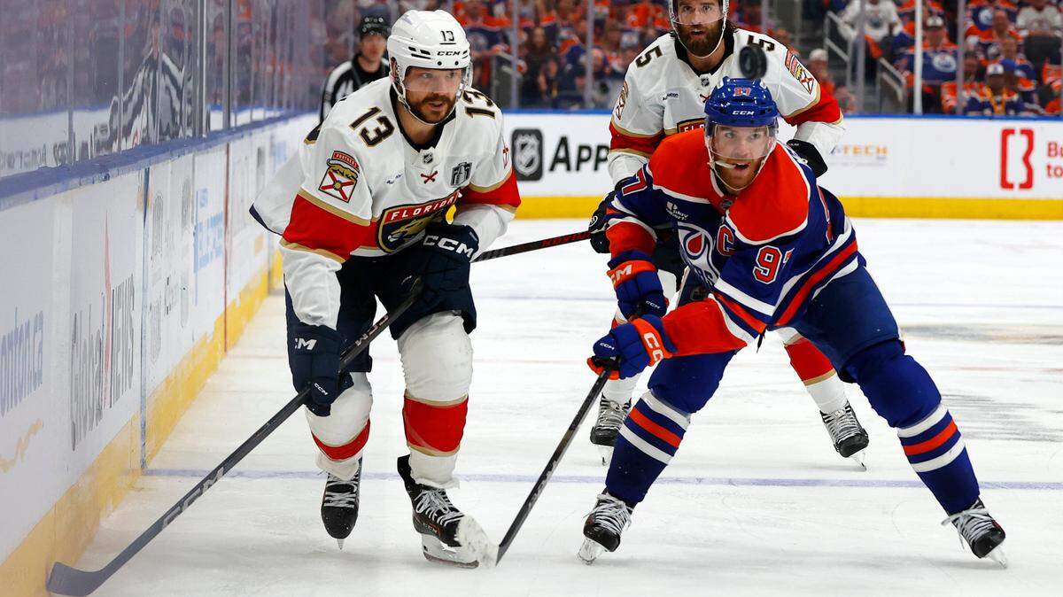 Jun 6, 2025; Edmonton, Alberta, CAN; Edmonton Oilers center Connor McDavid (97) skates past Florida Panthers center Sam Reinhart (13) during overtime in game two of the 2025 Stanley Cup Final at Rogers Place.