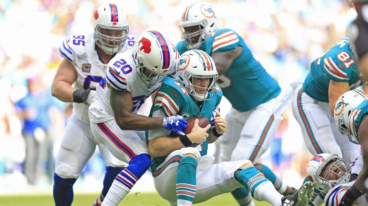 Miami Dolphins quarterback Ryan Tannehill (17) is sacked by Buffalo Bills defensive back Rafael Bush (20) in the first quarter as the Miami Dolphins host the Buffalo Bills on Sunday, December 2, 2018.