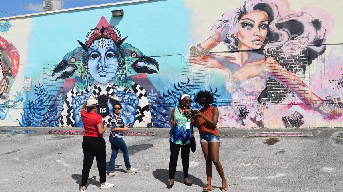 Participants of the Hispanic Heritage Month Neighborhood Tour take photos at the Leah Arts District in Hialeah.