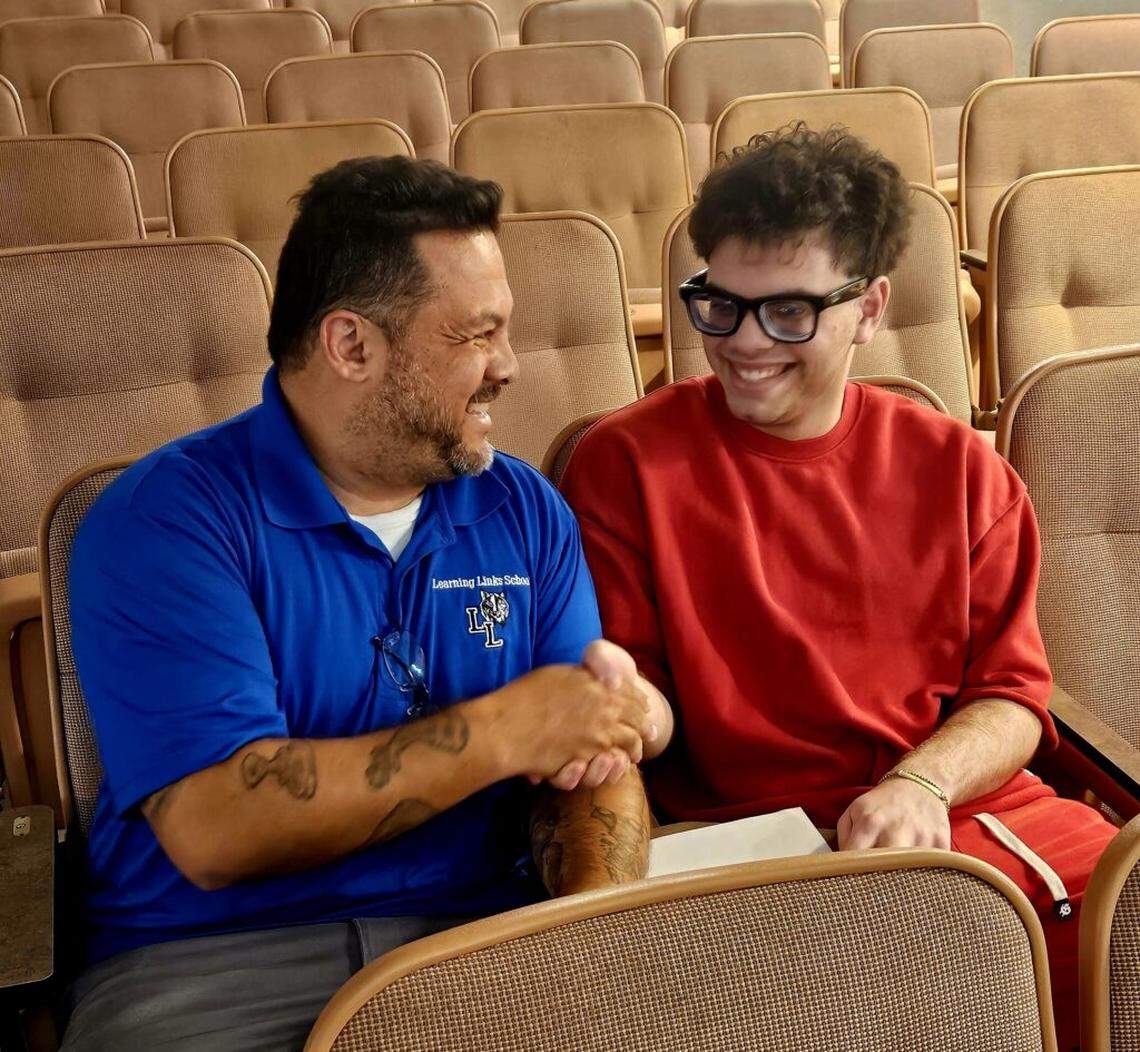 John Acevedo, left, coach of Piano Slam finalist Kaleb Duarte, helps students bring personal stories to the stage. “Don’t just read the poem — tell them what you went through,” he said.