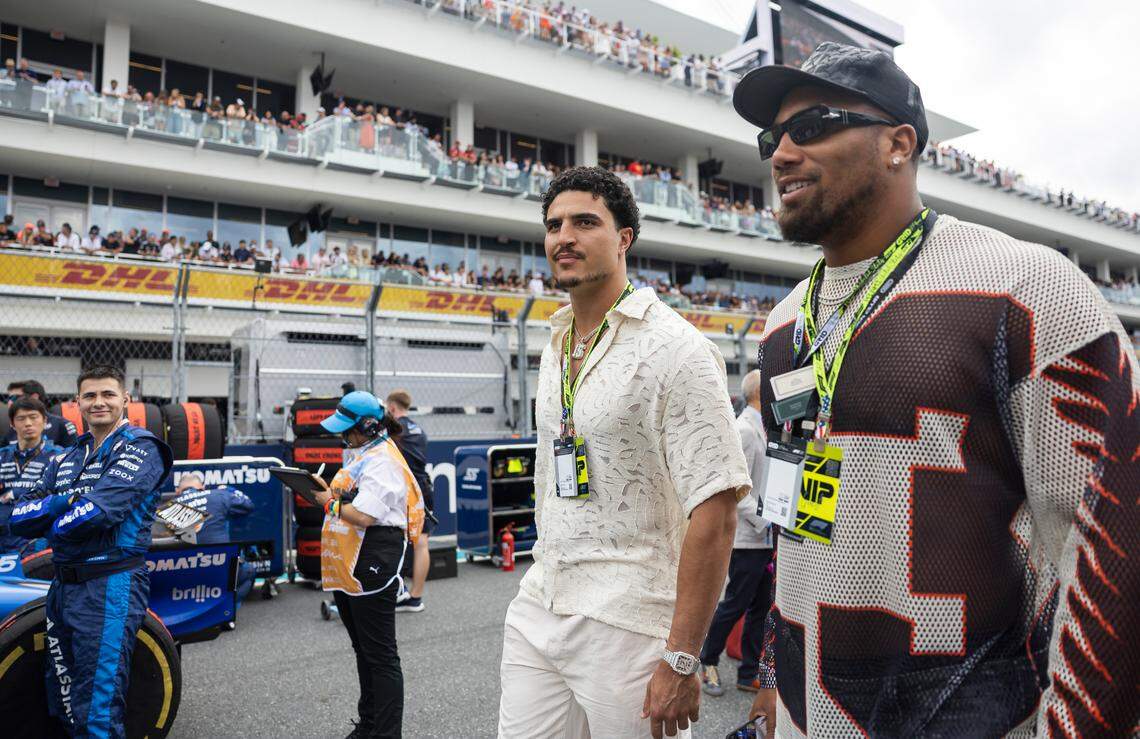 Miami Dolphins linebackers Jaelan Phillips (15) and Bradley Chubb (2) walk the grid ahead of the Formula One Miami Grand Prix at the Miami International Autodrome on Sunday, May 4, 2025, in Miami Gardens, Fla.