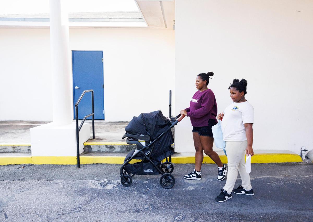 Breyana Kipp, left, picks up her daughter Leyla, 9, from school with her 1-month-old during the afternoon on Wednesday, Nov. 13, 2024, at Liberty Academy, a school and aftercare facility in Liberty City. Kipp found out about Liberty Academy from her niece.