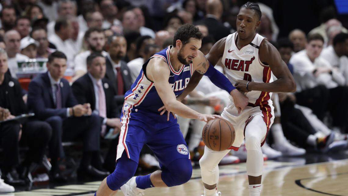 Miami Heat's Josh Richardson, right, defends Philadelphia 76ers' Marco Belinelli during the second half of Game 3 of a first-round NBA basketball playoff series, Thursday, April 19, 2018, in Miami. The 76ers won 128-108. (AP Photo/Lynne Sladky)