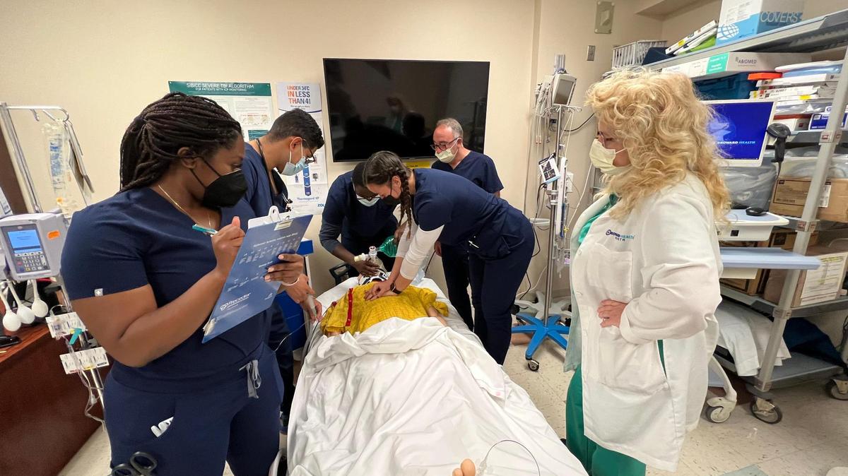 Nicole Puleo, a Broward Health clinical nurse educator, at right, and Paul Brattan, in the back right, also a Broward Health clinical nurse educator, train nurses to work in the ICU as part of the hospital’s Critical Care Internship program.