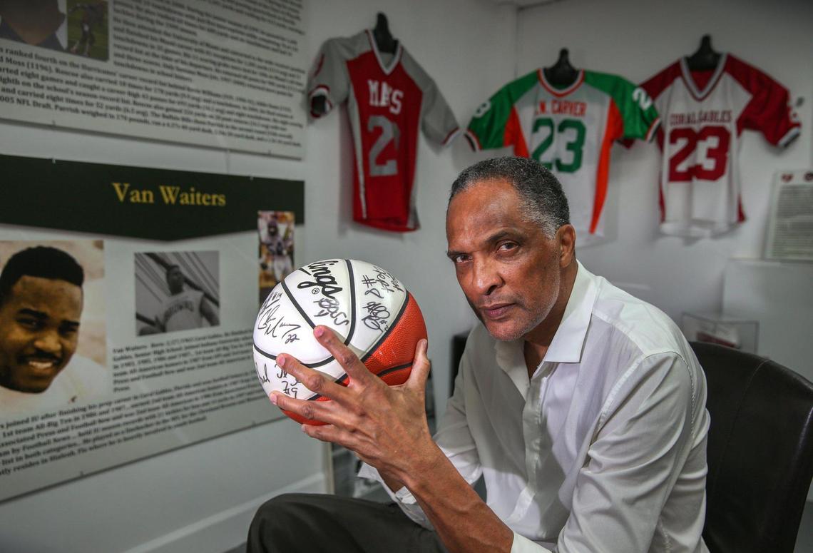 Anthony Witherspoon, a former college basketball player and coach, poses with a signed basketball at the Coconut Grove Sports Hall of Fame opening soon. He came up with the idea for the museum to honor notable high school, college and professional athletes from the historically Black but rapidly gentrifying West Grove, where he was born and raised.