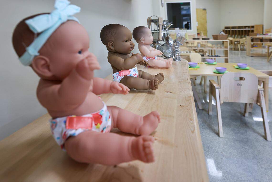 Lotus Hour executive director Isabella Dell'Oca stands at the entrance below a lotus designed light fixture as she gave a tour of the newly built 70,000 square foot Children Village, where 14 nonprofits focus on the education, health, and therapeutic needs of children of Lotus House clients and members of the surrounding community on Thursday, November 13, 2025, in Miami, Florida.