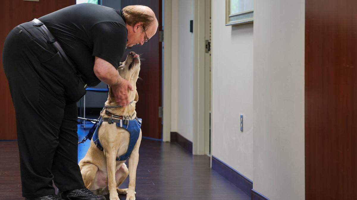 Jose Lopez Masso, Vice President of Public Affairs and Government Relations at Lighthouse of Broward, with his guide dog, Mr. Louis, outside his office on Wednesday, July 9, 2025, in Sunrise, Florida. 