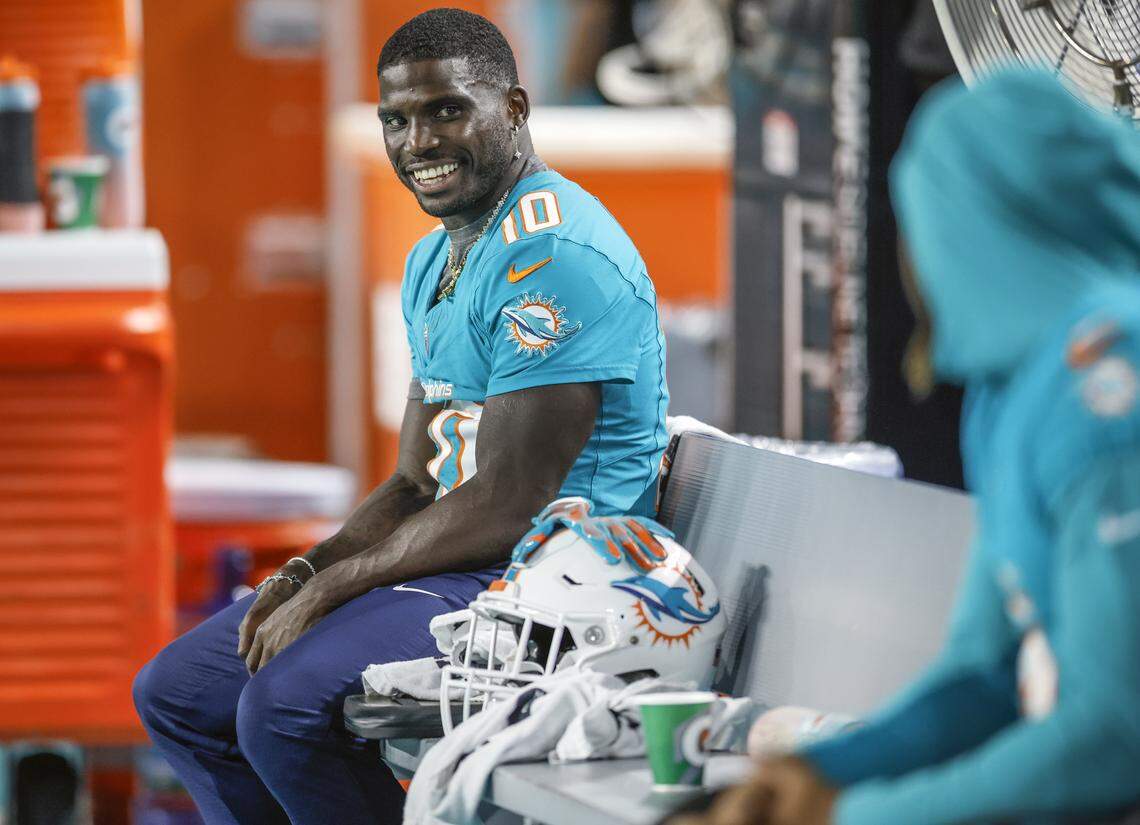 Miami Dolphins wide receiver Tyreek Hill (10) on the bench during an NFL football game against the Jacksonville Jaguars at Hard Rock Stadium in Miami Gardens, Florida, on Saturday, August 23, 2025.