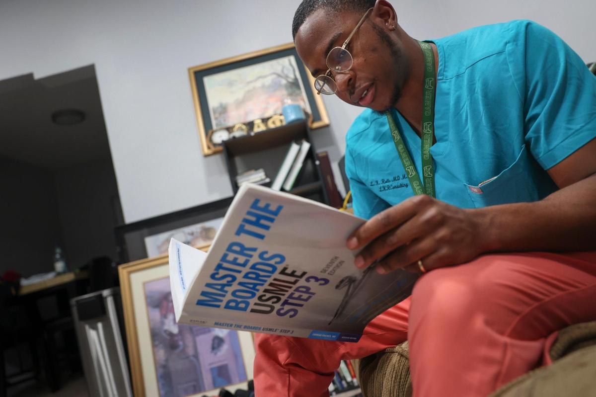 Dr. Lawrence Rolle studies for an upcoming exam after a long day of work in Miami. Rolle is a second-year resident at Jackson Memorial Hospital. He struggled mightily to buy a house, before finally landing one in Liberty City.