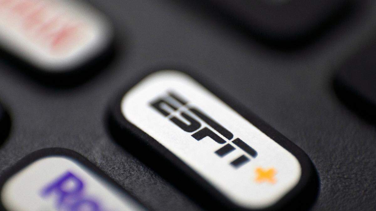 This Aug. 13, 2020, photo shows a logo for ESPN on a remote control in Portland, Ore.