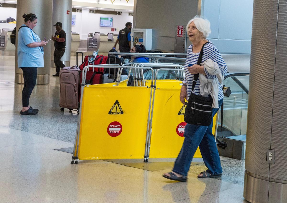 Kathy Jones was forced to walk up the stairs to the second floor of Miami International Airport on Thursday, Jan. 18, 2024, after encountering a disabled escalator in Concourse G . Her climb came the same morning Miami-Dade County Mayor Daniella Levine Cava held a press conference to provide an update on the county’s maintenance and infrastructure upgrades at the airport.
