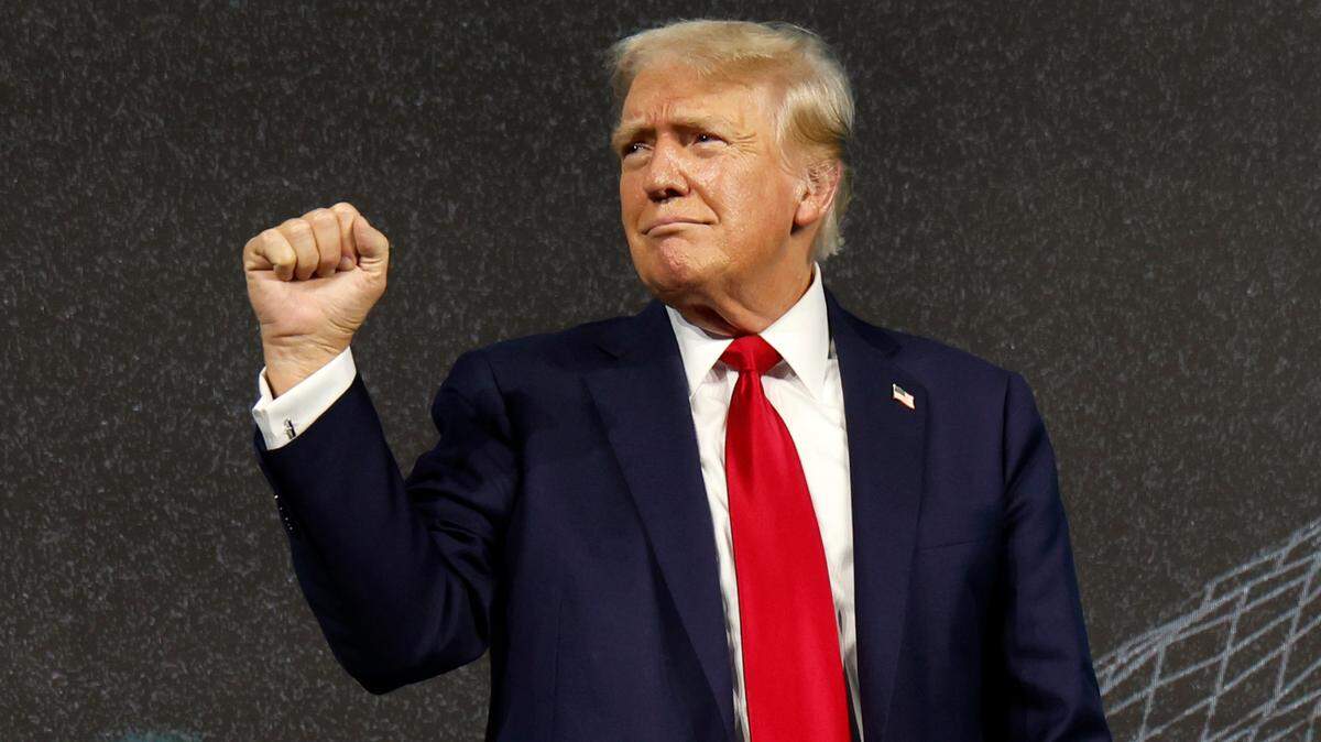 Former President Donald Trump pumps his fist during the Turning Point Believers Summit at the Palm Beach County Civic Center on Friday, July 26, 2024.