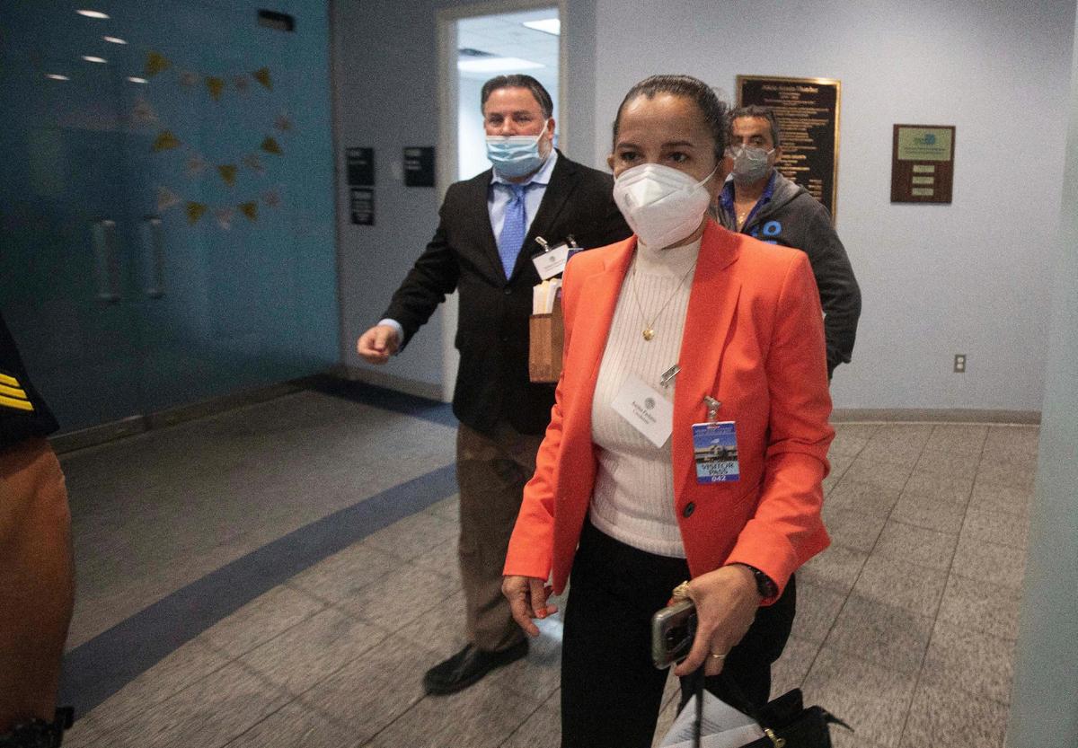 Karina Pacheco leaves the Miami Dade Supervisor of Elections with her lawyer Michael Pizzi and her husband Councilman Ivan Pacheco (back), on Friday Jan. 28, 2022, after a recount confirmed her victory in Tuesday’s special town council election. Pacheco will join her husband on the council.