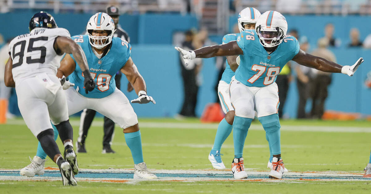 Miami Dolphins offensive tackle Larry Borom (79) and guard James Daniels (78) set up to block against the Jacksonville Jaguars in the first half of an NFL football game at Hard Rock Stadium in Miami Gardens, Florida, on Saturday, August 23, 2025.
