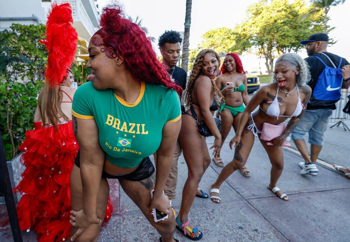 Spring breakers,Treasure M.. Bria F. and Samiyah Emani, dance on the sidewalk with Lala Torres, wearing feathers at left, in front of the Clevelander Hotel along Ocean Drive, Miami Beach, Florida on Friday, March 14, 2025.