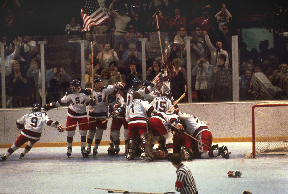 The U.S. hockey team pounces on goalie Jim Craig after a 4-3 victory against the Soviets in the 1980 Olympics in Lake Placid, N.Y.