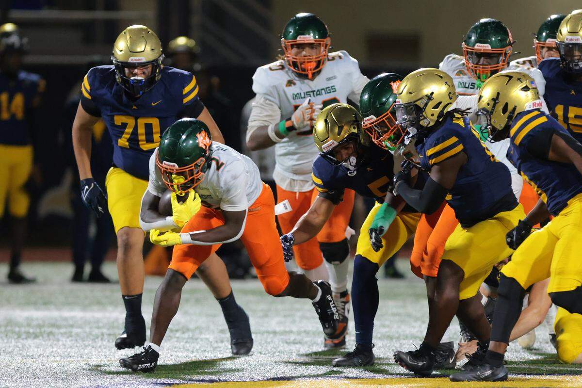 McArthur running back Kenson Louis (2) carries the football against St. Thomas Aquinas during the third quarter of a Region 4-5A final football playoff game at St. Thomas Aquinas High School on Friday, Nov. 28, 2025, in Fort Lauderdale, Fla.