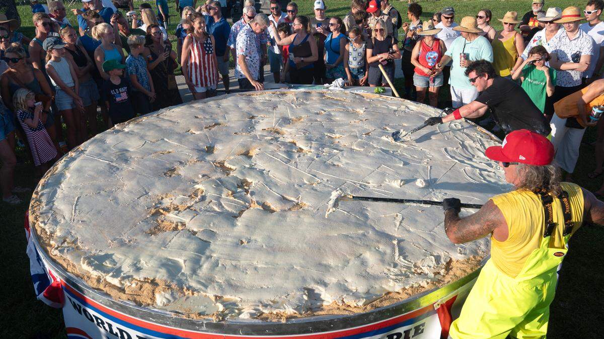 Chefs Paul Menta, front right and David Sloan, back right, put finishing touches on a gargantuan Key lime pie created for a 200th Florida Keys birthday celebration Monday, July 3, 2023, on Big Pine Key. The festivities took place on the 200th anniversary of the Florida Territorial Legislature’s establishment of Monroe County, which contains the entire Keys island chain and a portion of Everglades National Park, on July 3, 1823. The pie measured 13.14 feet in diameter and contained 16 gallons of Key lime juice.