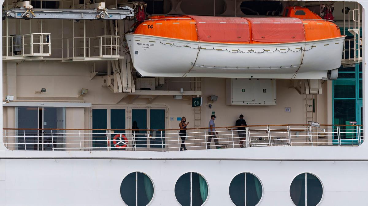 Crew members aboard Royal Caribbean’s Vision of the Seas can be seen as the ship is docked at PortMiami on Friday, May 15, 2020, in Miami, Florida.
