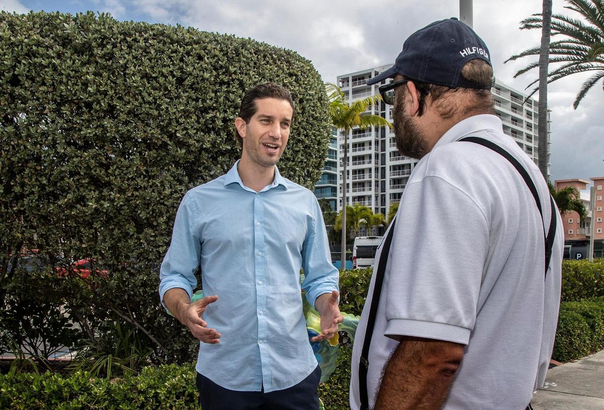 Newly elected Surfside Mayor Shlomo Danzinger talks with part-time resident Jerry Freund in front of Town Hall on Wednesday, March 23, 2022.