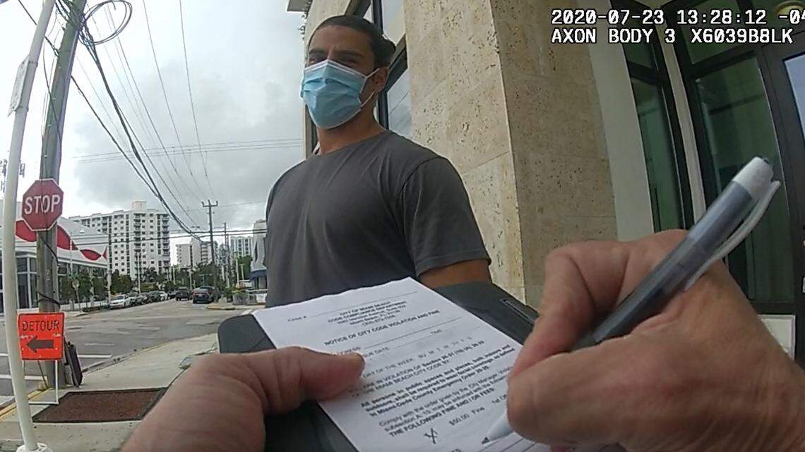 A man is fined by Miami Beach Code Compliance for violating the city’s mandatory face-mask rule on July 23.