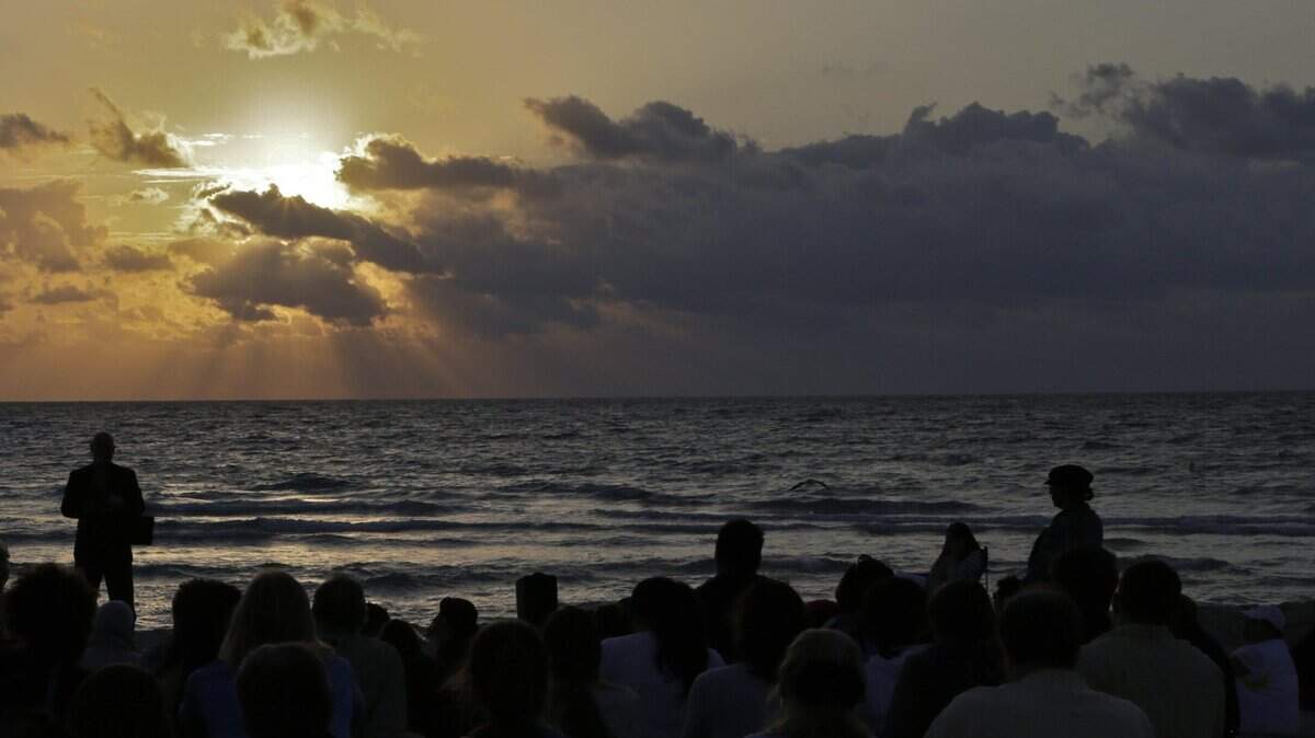 Worshipers arrive for Calvary Chapel Easter sunrise service. Members of New Life Missionary Baptist Church of Liberty City and Calvary Chapel of Miami Beach held baptisms and Easter sunrise services at the beach behind the Miami Beach’s bandshell on Easter Sunday, March 31, 2013. This year, due to the pandemic, some services have been canceled but people will still celebrate the holiday.