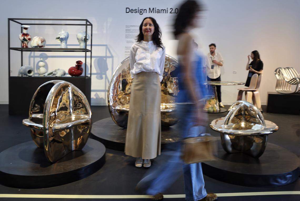 Miami Beach, FL, December 2, 2025 -  San Francisco artist Tina Frey stands still as a fair goer zips by while special project Design Miami 2.0 showcased her piece created after days of meditation during the opening day for Design Miami XX in Miami Beach, Florida