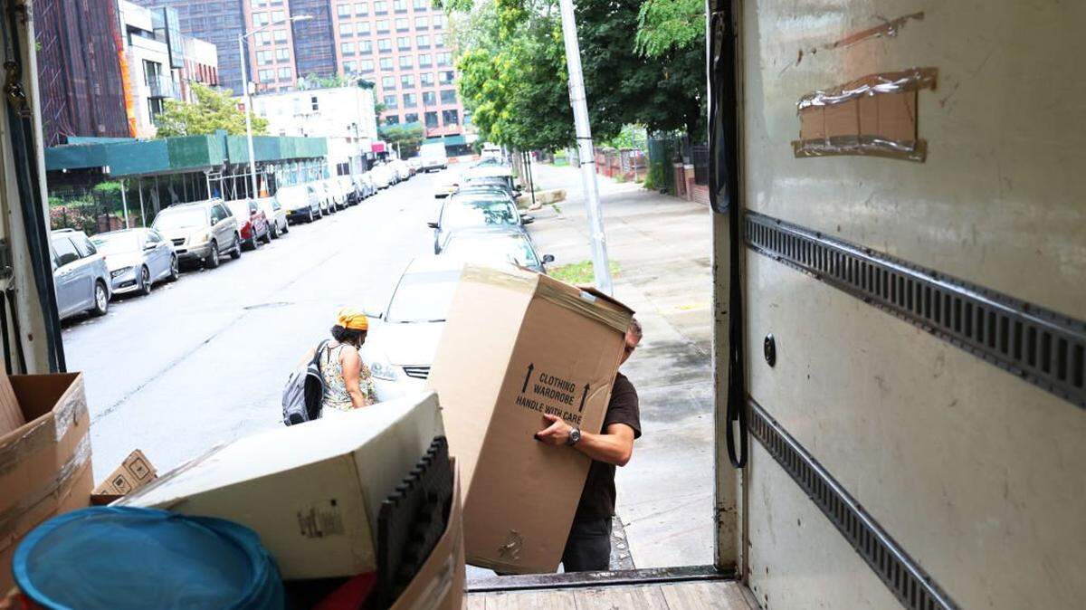 NEW YORK, NEW YORK - AUGUST 13: Dusan B., a mover with Rabbit Movers, places the belongings of a customer unto a moving truck on August 13, 2020 in New York City. Moving companies are increasingly trying to keep up with higher demand as an uptick of people are choosing to move from New York City during the COVID-19 pandemic. (Photo by Michael M. Santiago/Getty Images)