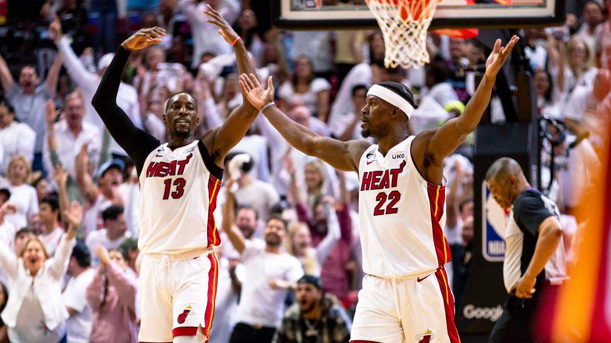 Miami Heat forward Jimmy Butler (22) and center Bam Adebayo (13) react during the second half of Game 3 of the NBA Eastern Conference Finals series against the Boston Celtics at Kaseya Center in Miami, Florida, on May 21, 2023.