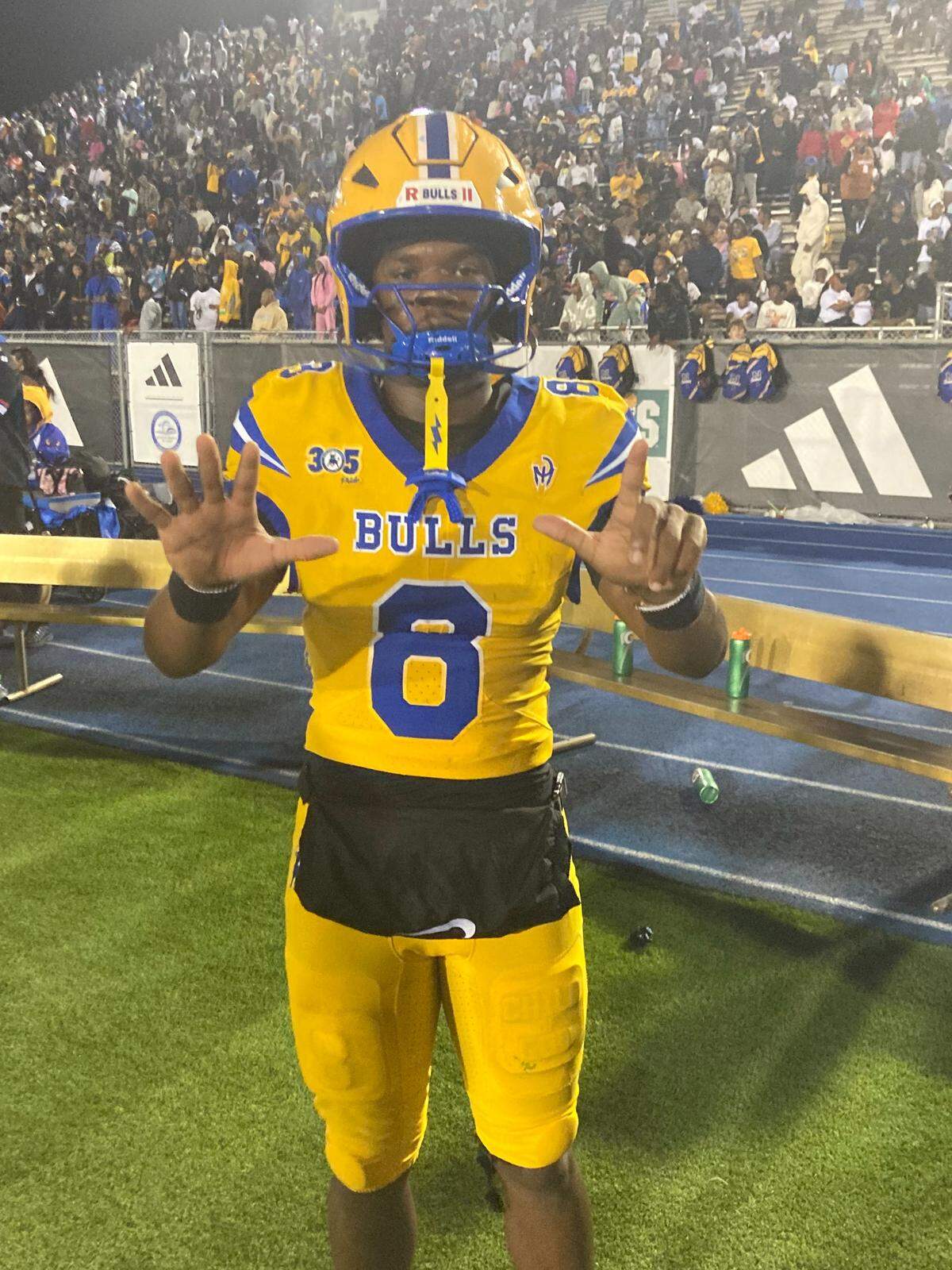 Northwestern quarterback Neiman Lawrence holds up seven fingers signifying the amount of touchdown passes he threw on Saturday during a 50-29 Bulls’ win over Miami Central in the Region 4-3A final at Traz Powell Stadium in Miami, Fla.