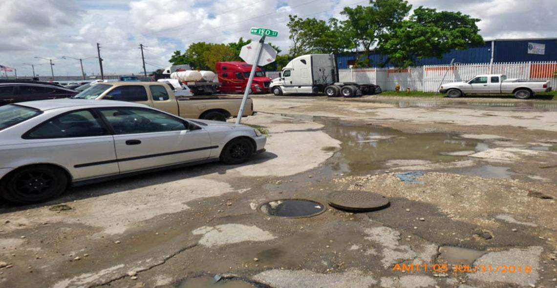 A manhole leaks raw sewage into the streets on July 31. It then mixed with flood water to create a health emergency.