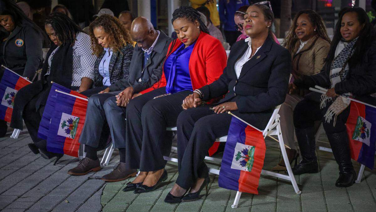 Public officials from Miami-Dade County, the City of Miami and North Miami, along with community members, bow their heads in prayer during the prayer candle light vigil at the Little Haiti Cultural Complex on Feb. 3, 2026, in Miami. The event, held in support of the local TPS community, included prayer, reflection and calls for unity and hope. From left to right are former state legislator Daphne Campbell, left, Miami Commissioner Christine King, Mayor of North Miami Alix Desulme, North Miami Vice Mayor Kassandra Timothe, and North Miami Councilwoman District 3 Councilwoman Mary Estimé-Irvin.