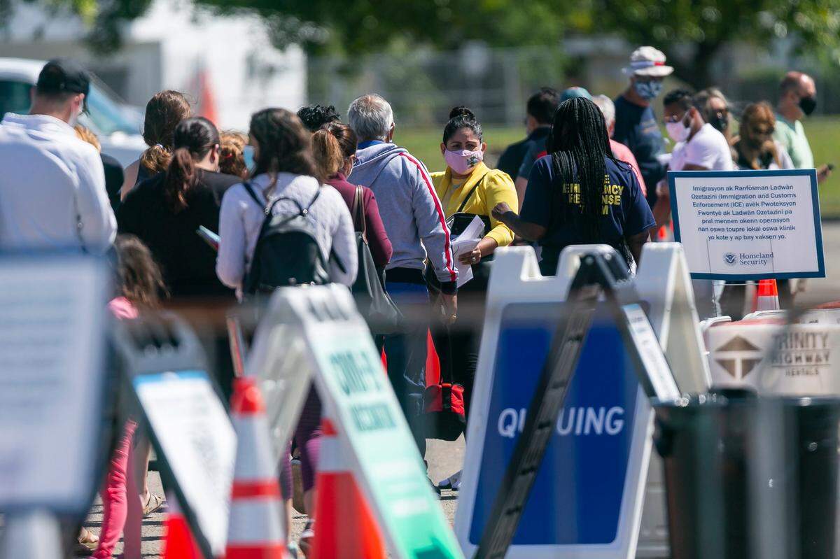 People line up to receive a COVID-19 vaccine at the Miami Dade College North vaccination site in Miami, Florida on Sunday, March 7, 2021.