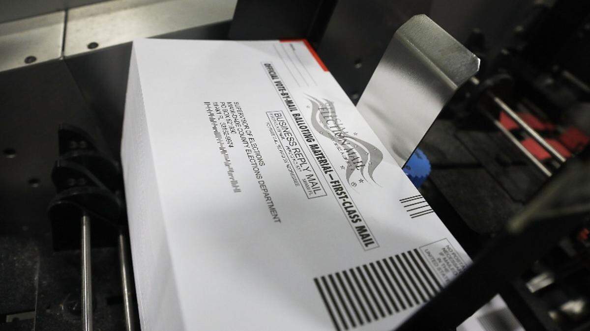 Mail-in ballots are processed to be sent out to voters at Miami-Dade Election Department headquarters.