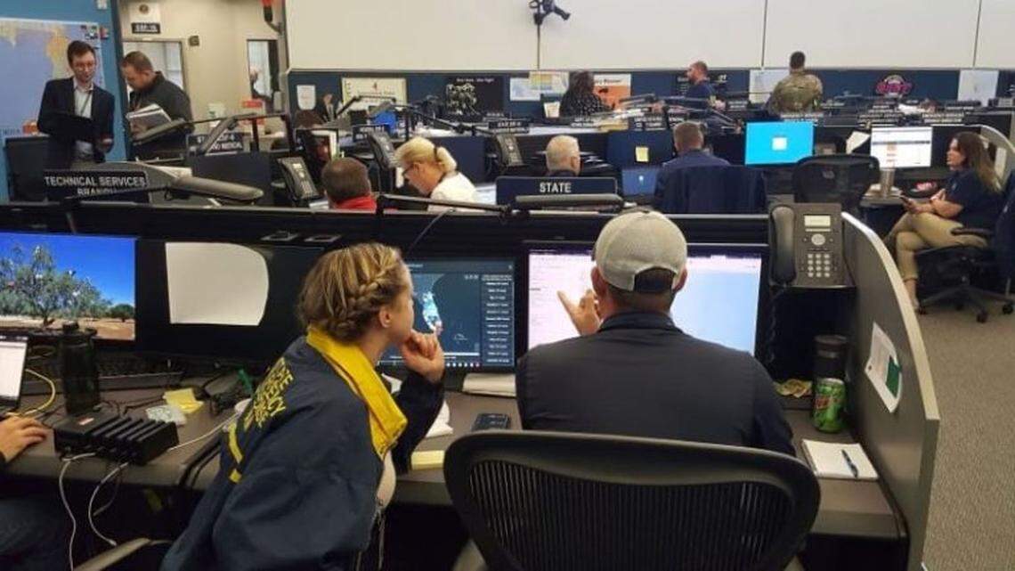 Rebekah Jones, left, discusses her COVID map with emergency management’s Jason Ray, right, in the emergency operations center in the spring of 2020.