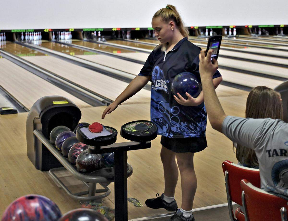 Coral Springs Charter School eighth-grader Katarina Hagler, 13, warms drys her hand as she bowls with teammates and is on the verge of setting county, state, and national records bowling average as she competes at Sawgrass Lanes in Tamarac, Florida on Thursday, October 17, 2019.