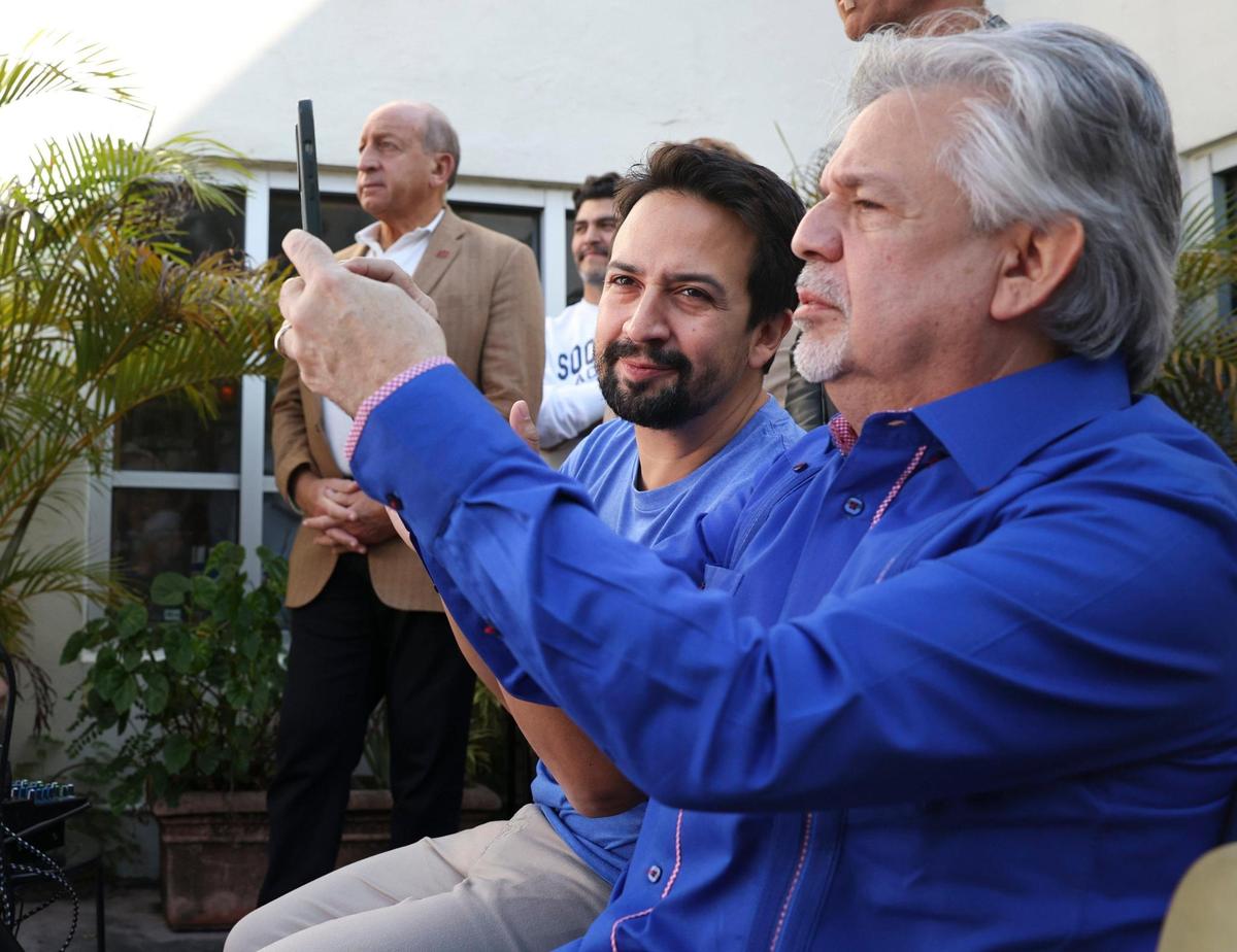 Lin-Manuel Miranda, award-winning artist, center, and his father, Luis A. Miranda, right, attend a Latino Victory Fund’s Get Out The Vote Rally for Florida Democrats on Thursday, Oct. 20, 2022, at Books & Books in Coral Gables.